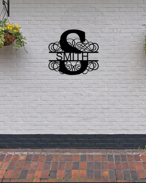 Powder-coated metal split-letter monogram on a brick wall