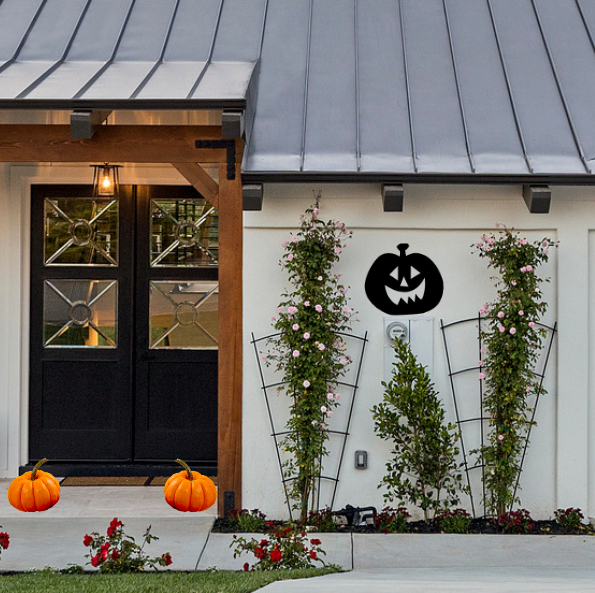 Powder-coated metal Happy Jack-o-Lantern Halloween yard sign on a Canadian home exterior