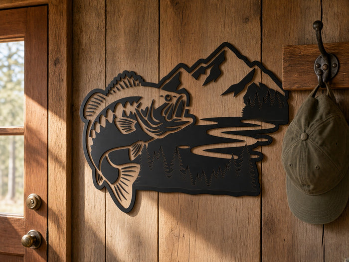 Fish and mountain metal wall art shown on a wood-paneled cabin wall