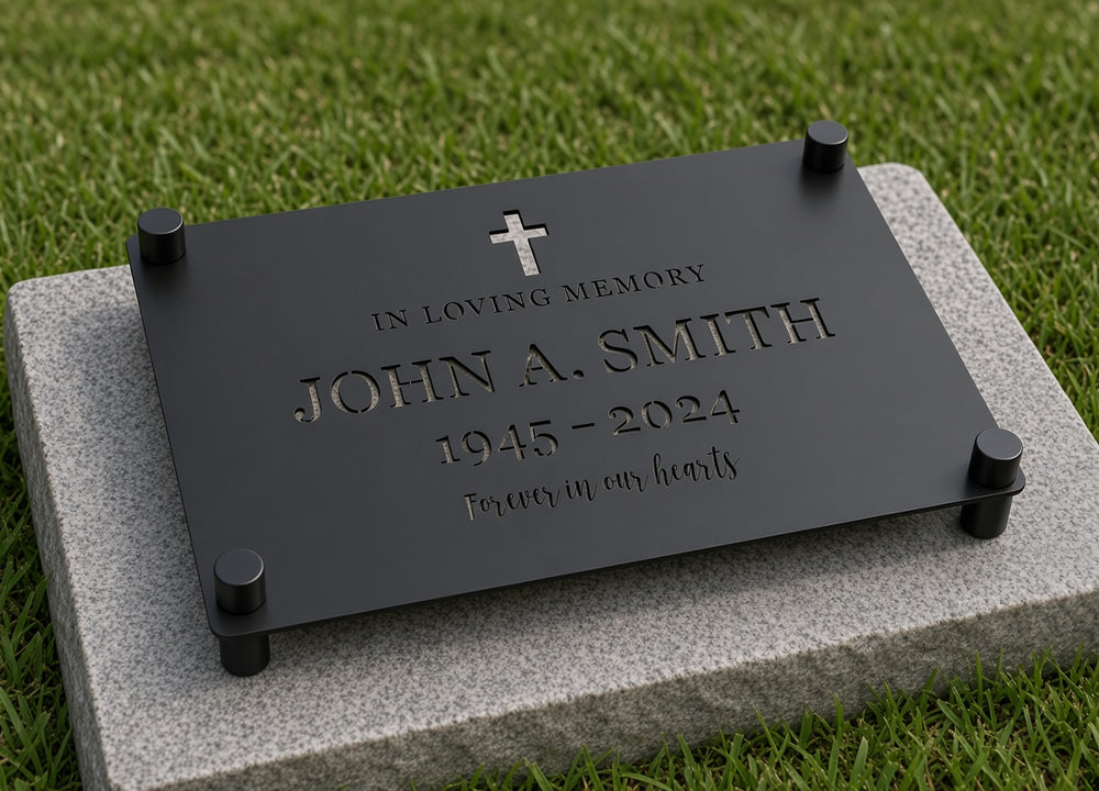 Memorial grave plaque on four black standoffs on a granite slab, all corners shown